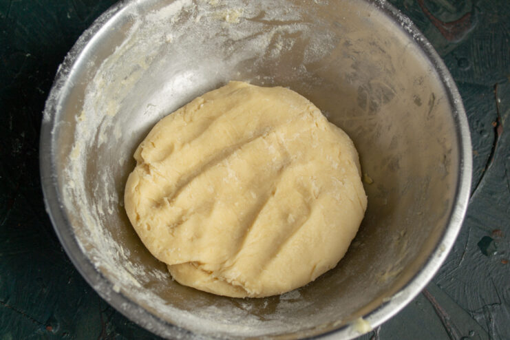 Chilling the Dough Round ball of cookie dough resting in a flour-dusted bowl
