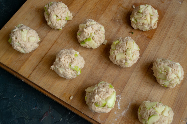 Rolled dough balls sitting on a wooden board