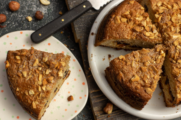 Sweet kefir cake topped with dates and cashews on a platter