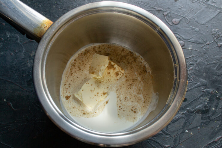 Heating the spiced cream Warming heavy cream, butter, ground cinnamon, and ginger in a small saucepan