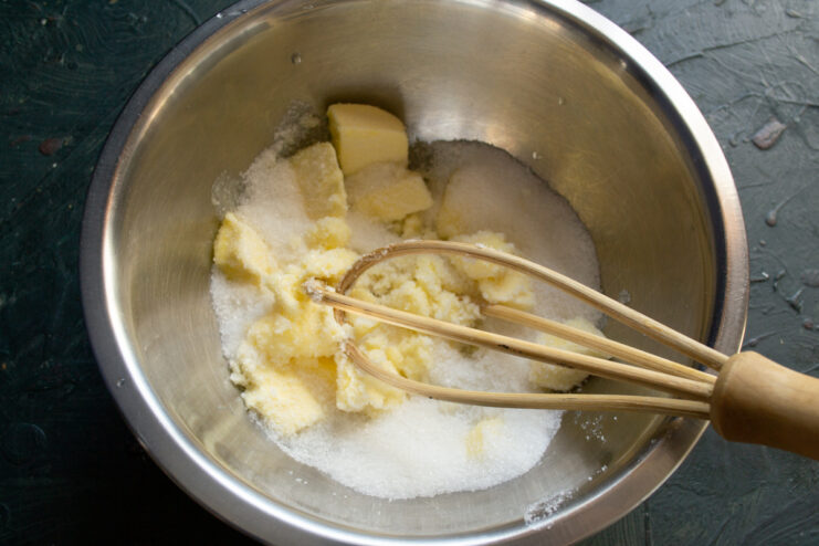 Creaming butter and sugar Softened butter and sugar mixed together in a bowl