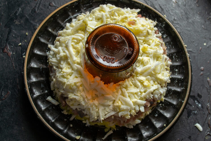 Egg layer Grated hard-boiled eggs layered over herring and mayonnaise