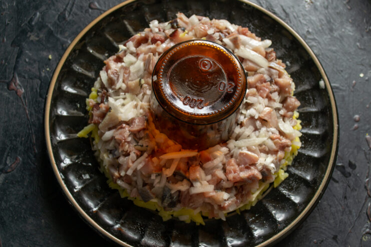 Herring layer Layer of diced herring and onion spread evenly over the potato base