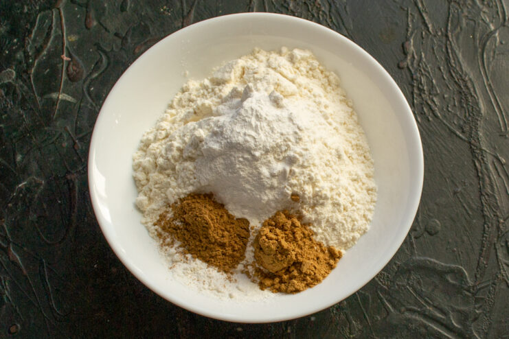 Preparing dry ingredients Mixing flour and spices in a bowl for carrot cookies