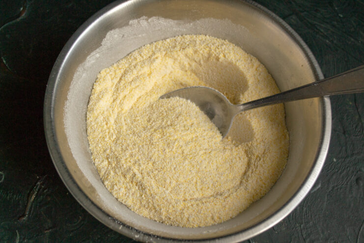 Mixing the flour Mixed polenta and whole wheat flour in a metal bowl.