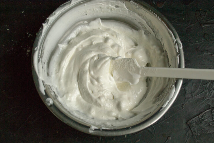 Preparing the soufflé cream Folding whipped egg whites into ricotta and cornstarch mixture