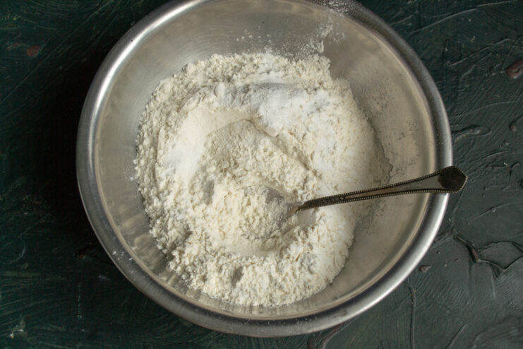 Dry ingredients Mixing wheat flour and baking powder together in a bowl