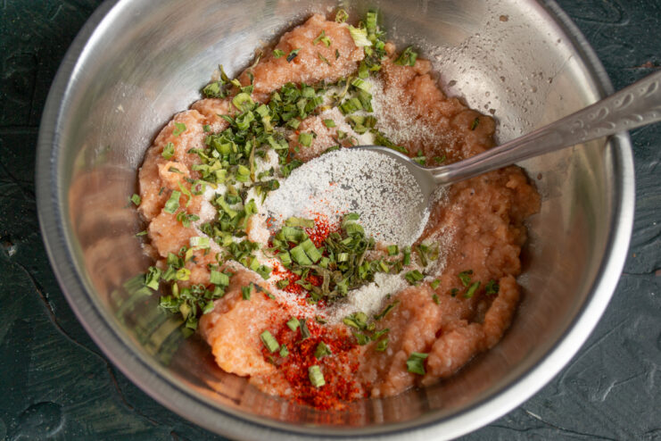 Adding dried herbs Blending dried green onions into the minced fish mixture