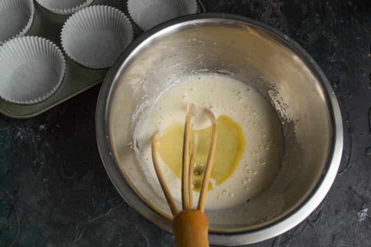 Whisking egg mixture with vegetable oil and milk