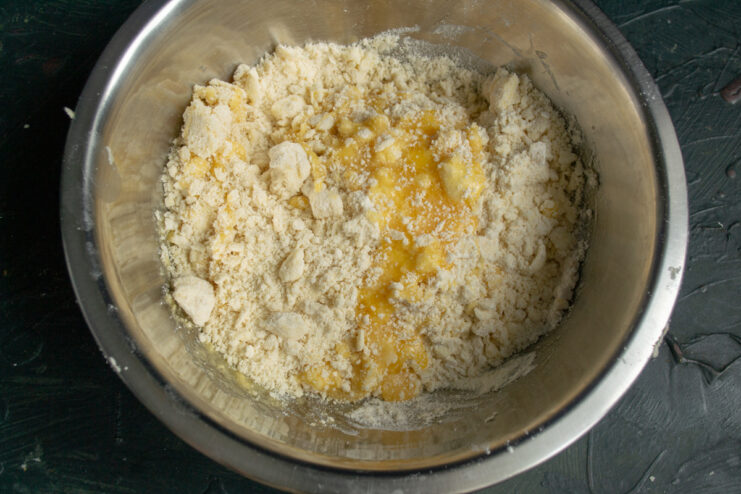 Kneading the dough Pouring the egg mixture into the buttery flour crumbs