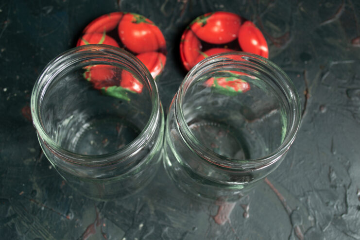 Sterilizing glass jars in the oven Empty, clean glass jars and metal lids ready for canning