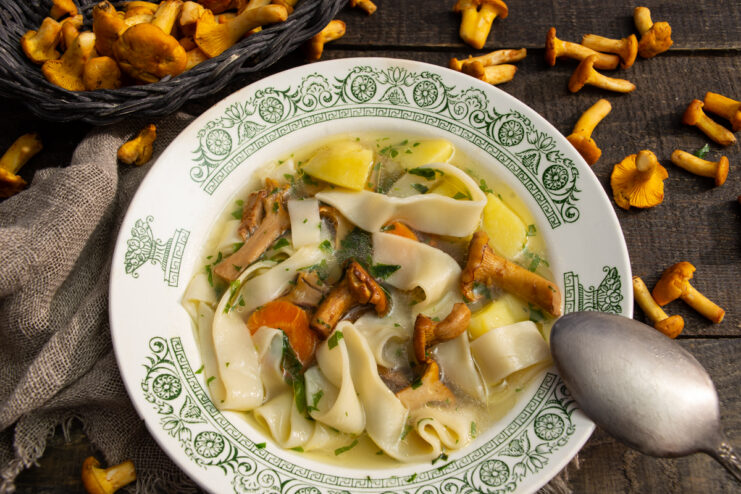A bowl of fragrant homemade soup with wild chanterelles and tender noodles