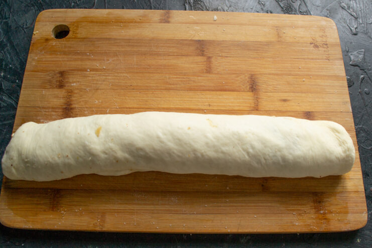 Rolling the dough Rolling the rectangular dough sheet with filling into a tight cylindrical log