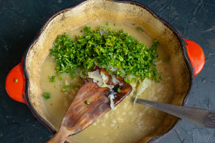 Adding Fresh Parsley Freshly chopped parsley mixed into the pot of kulesh
