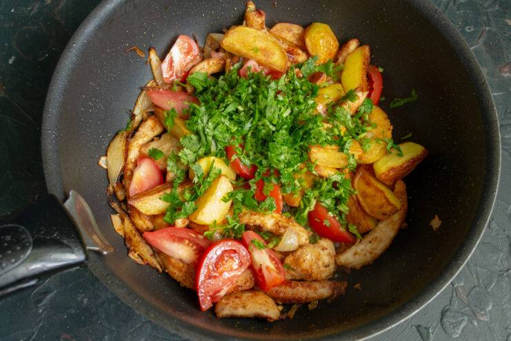 Adding fresh cilantro Sprinkling fresh chopped cilantro into the skillet