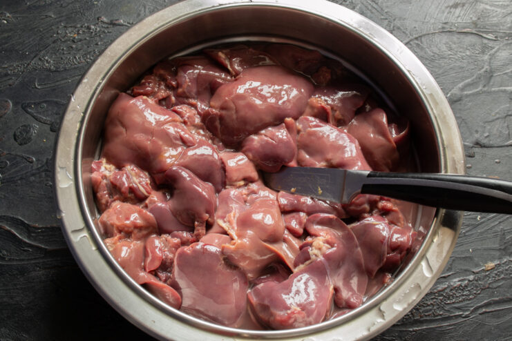 Preparing chicken liver Raw chicken liver prepared for cooking in a metal bowl.