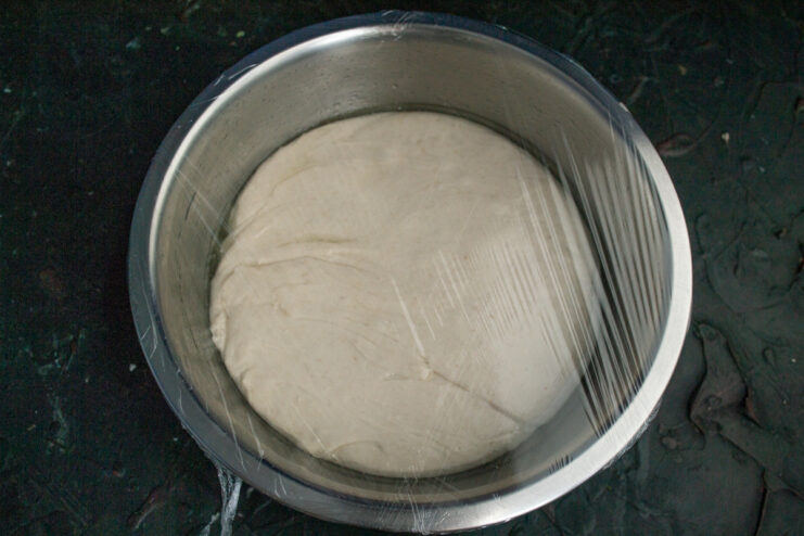 Proofing the dough Dough covered with plastic wrap for proofing
