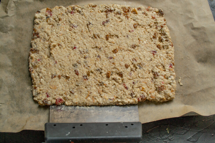 Shaping the dough on the pan Cookie dough spread into an even rectangle on parchment paper