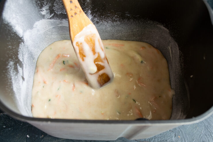 Raw cake batter spread evenly in a baking pan