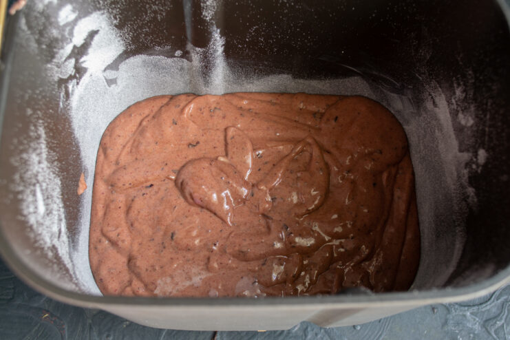 Preparing The Baking Pan Dark cake batter poured into a round baking pan