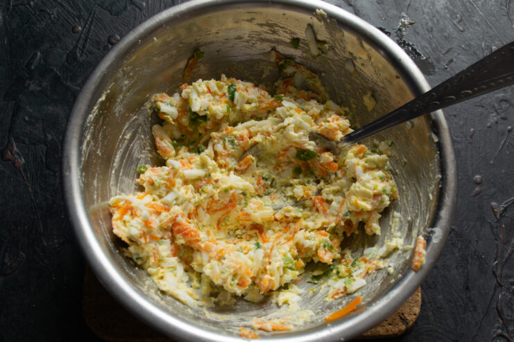 Thoroughly mixed herring roll filling in a glass bowl.