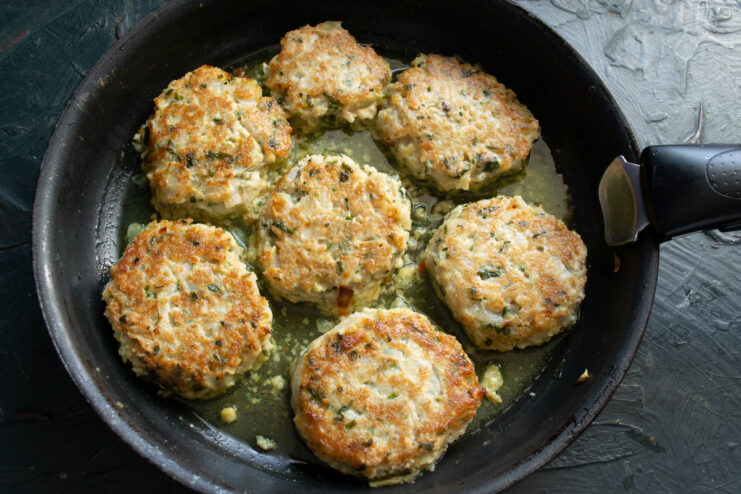 Simmering in Broth Oat patties simmering in seasoned broth inside a skillet
