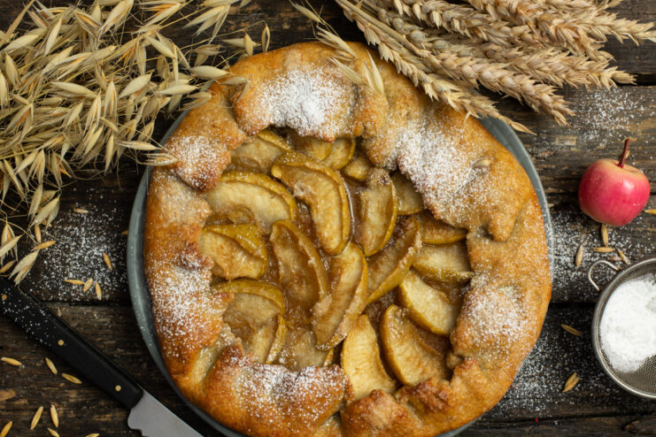 Rye crust apple ricotta galette on a wooden table