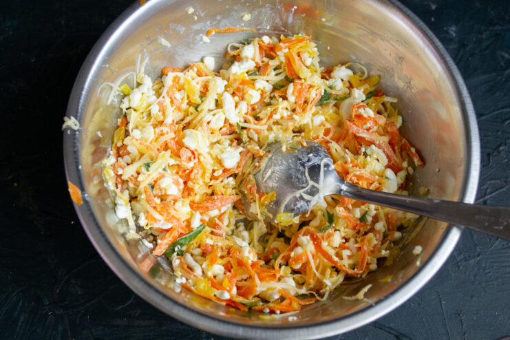 Finishing the filling Fully mixed cheese and vegetable filling with spices.