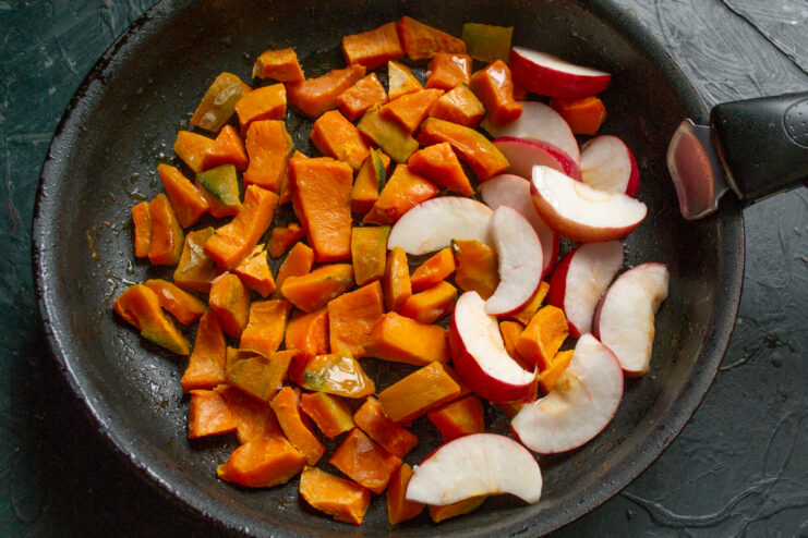 Sautéing pumpkin and apples Pumpkin and apples cooking in a skillet