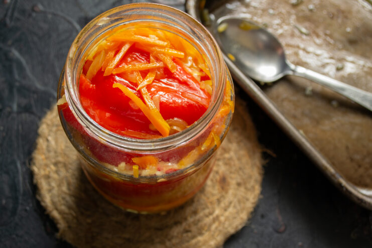 Canning the stuffed peppers Packing baked stuffed bell peppers tightly into a glass canning jar