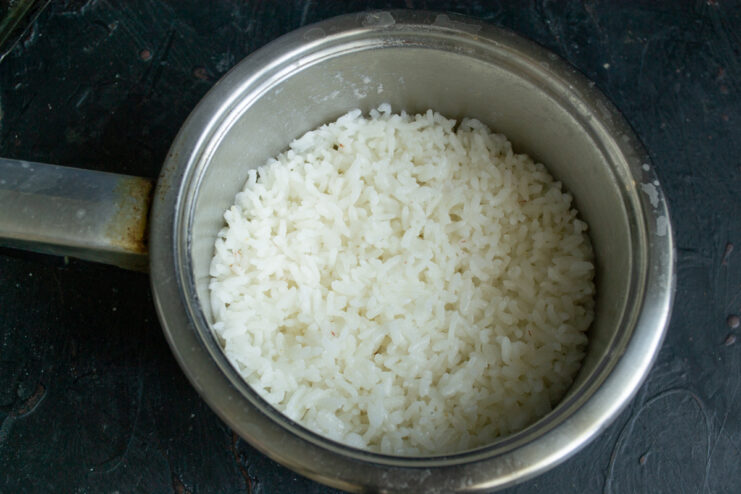Cooked white rice in a metal saucepan