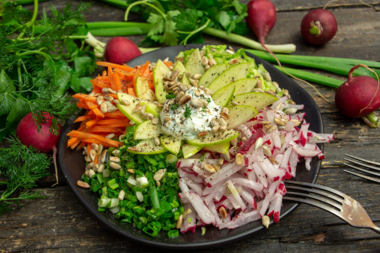 Vegetarian Goat in the Garden salad on a dark wooden background