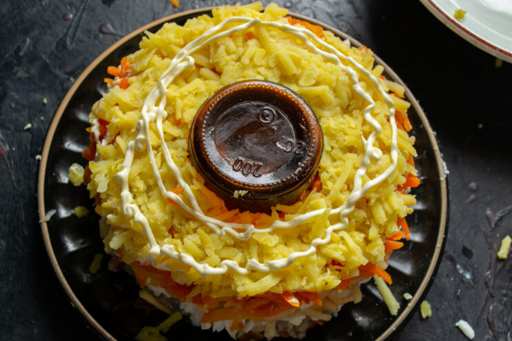 Final potato layer Second layer of grated potatoes topped with a mayonnaise net