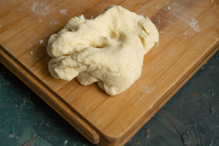 Kneading dough on a wooden surface