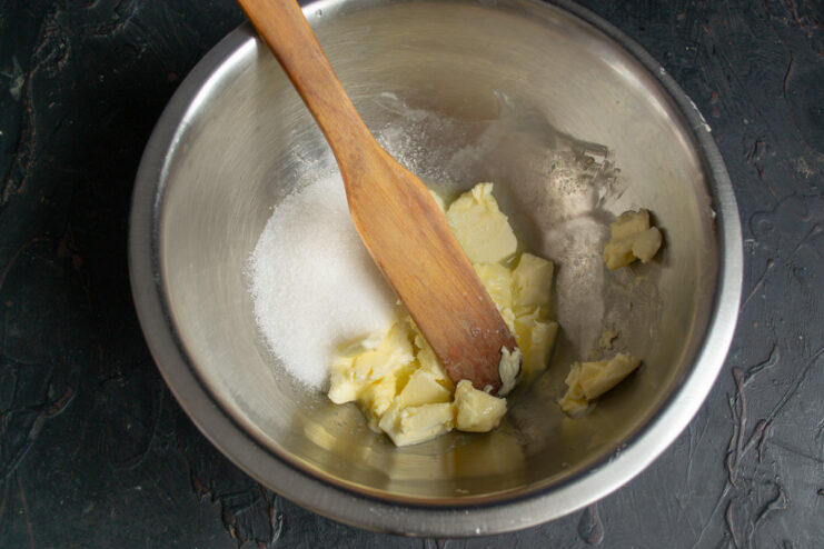 Whipped butter with sugar and egg in a bowl.