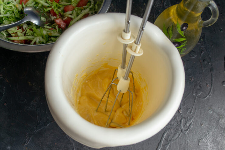 Finished Thick Homemade Mayonnaise Thickly whipped homemade mayonnaise inside a blender mixing cup with visible whisk trails.