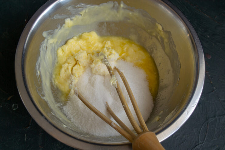 Preparing The Butter And Sugar Whisking softened butter with sugar in a metal mixing bowl