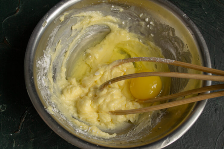 Beating the dough Whisking softened butter, powdered sugar, and an egg together.