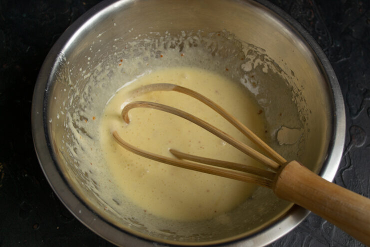 Whisking the ingredients Whisking an egg and sugar mixture in a glass bowl