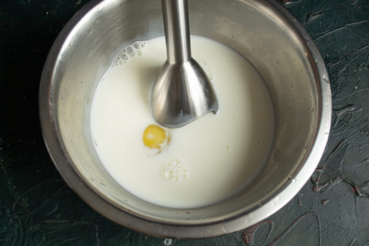 Blending eggs and milk with a hand blender