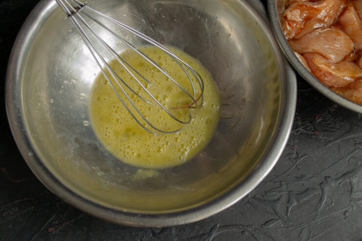 Whisking the eggs Whisking eggs in a glass bowl until smooth
