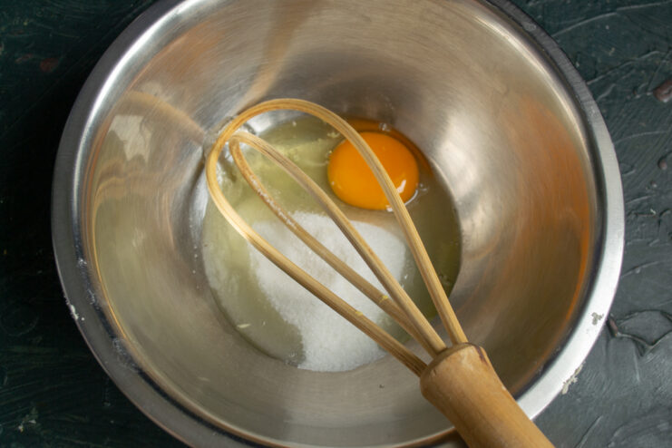 Egg mixture Whisking a fresh egg and sugar together in a small bowl