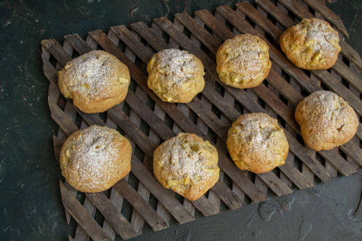 Soft apple cookies resting on a wooden cooling rack