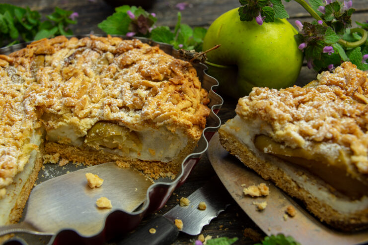 Baked apple soufflé pie with delicate filling and grated pastry crust