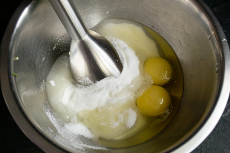 Eggs and granulated sugar mixed in a deep bowl