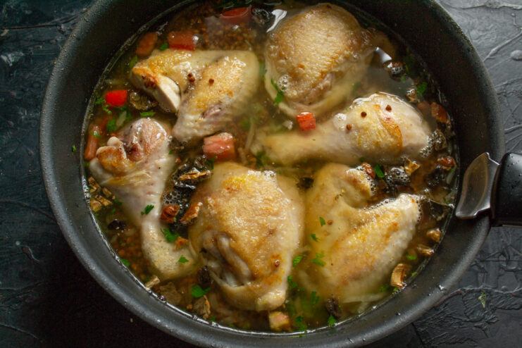 Adding Liquids Pouring broth over the dish in a skillet
