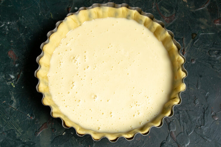 Pouring the filling Pouring the creamy ricotta filling into the prepared pastry crust