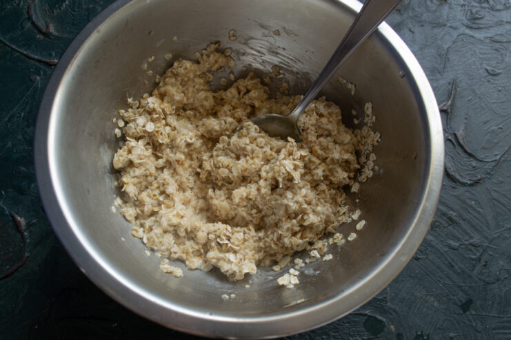Preparing the Oats Pouring liquid over quick-cooking oats in a bowl to soak