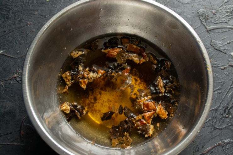 Preparing the Mushrooms Soaking dried mushrooms in a bowl of water