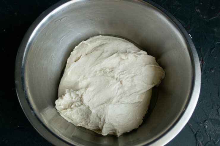 Finished dough Kneaded focaccia dough resting in a steel bowl